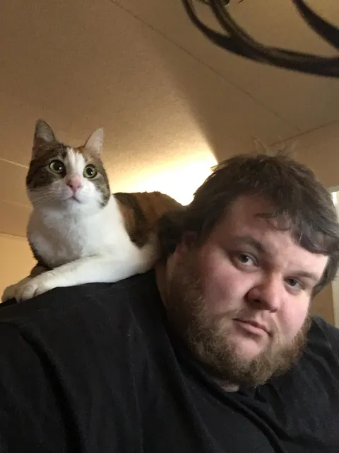 I met Criminal a month ago when I walked out of the shower at 4am and found her in my apartment. She was living in the woods behind my building and very scared of humans. I slowly built trust to coax her indoors, and now she is an extremely aggressive cuddler who will not leave my side.