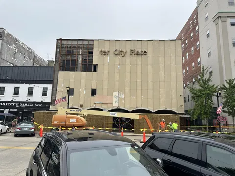 After 75 years, my city is removing this mostrosity of a facade and revealing the original building front