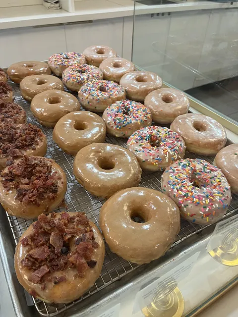 Tray of freshly glazed donuts.