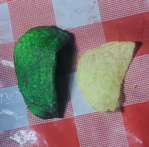 Concerning dark green lays potato chip I found. To the right: normal lays potato chip from the same bag (for comparison)