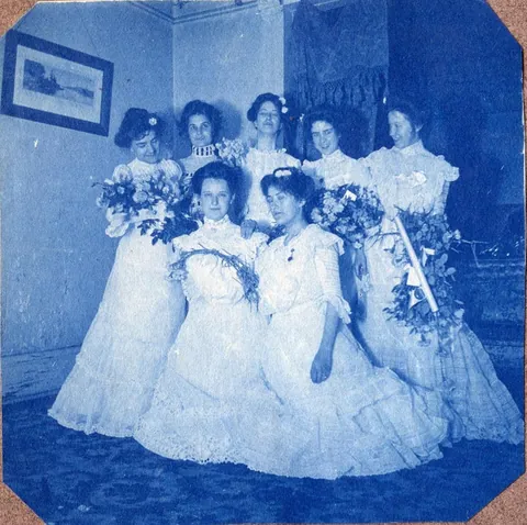 An unnamed young woman recorded her senior year at Asheville Female College in a photo album, Asheville, North Carolina, 1902. It includes a dorm room, group shots of friends, playing in snow, a visit to the mountains, their final midnight party before graduation, and graduation day itself.