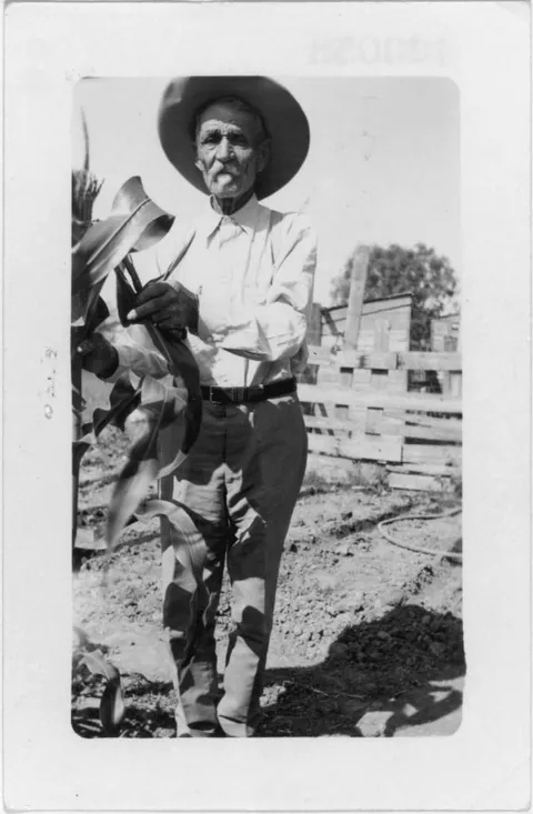 Ex-Slave Ben Kinchelow at his home tending his garden, Hondo, Texas, 22 of May (1937)