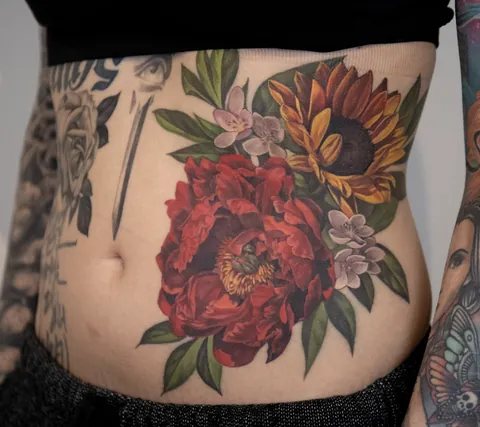 Floral stomach tattoo by Livia Tsang (@liviatsang) in Toronto, ON