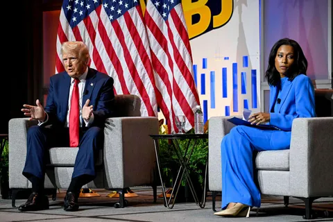 Rachel Scott looks away as Trump speaks at the National Association of Black Journalists