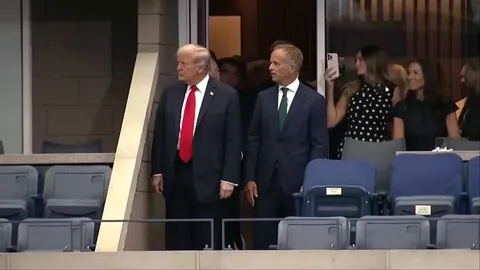 Donald Trump arrives at US Open men’s final to cheers and boos after broadcasters asked not to show reactions