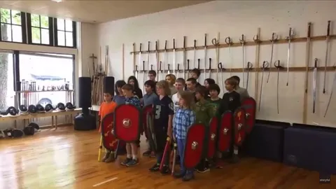 Kids demonstrating the effectiveness of the Roman testudo formation