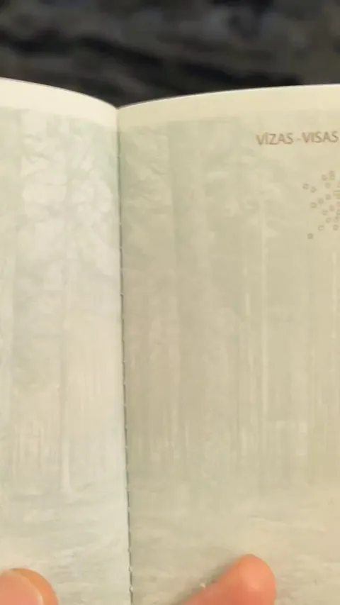 Latvian passport under UV lights.