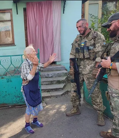 Meeting of Ukrainian military with a resident of a liberated village