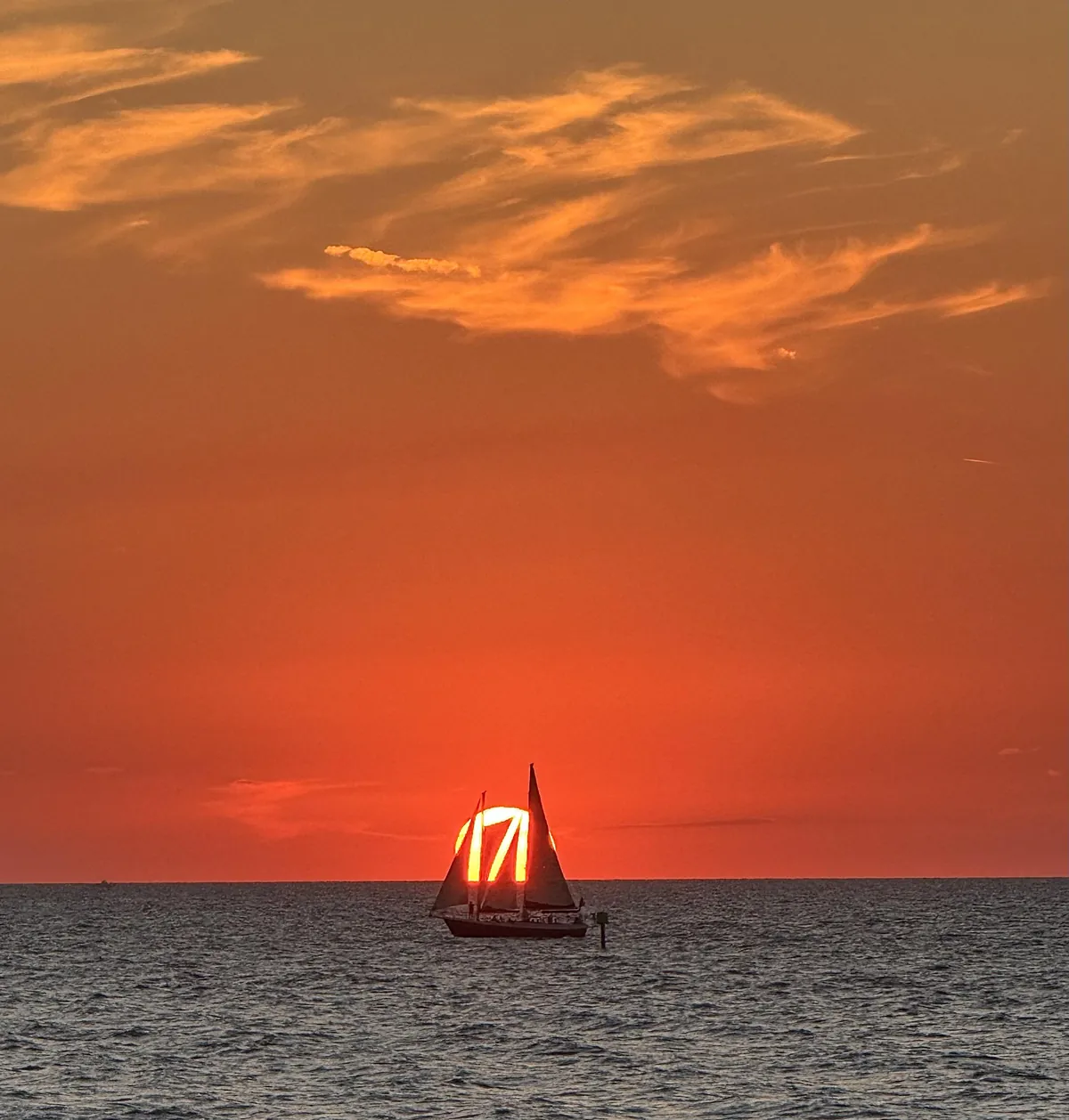 ITAP of a sailboat in front of a sunset
