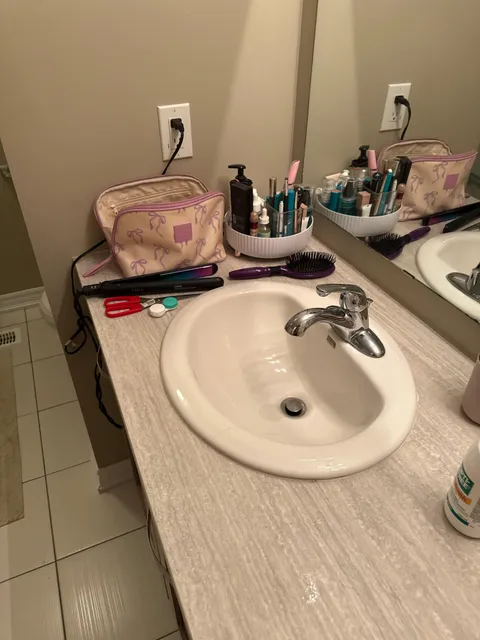 My wife puts my deodorant and my hair styling clay under the counter every day, but her side looks like this.