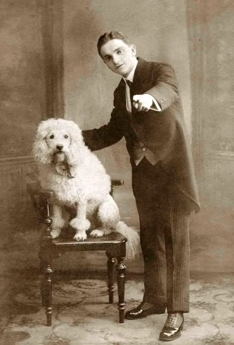 Gentleman pose for photos with their beloved pups, circa 1880-1900