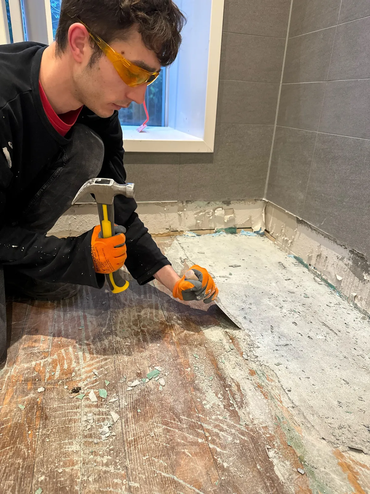 Help, someone put tile on this wood floor. How can we remove this grout easier than with a hammer and chisel. It’s taking forever.