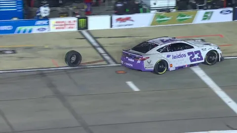 A rival NASCAR team helping a car which lost a tire