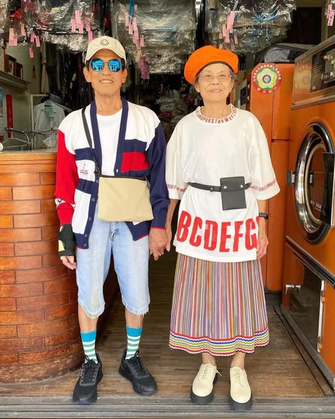 Taiwanese couple wear clothes that were left behind at their laundromat.