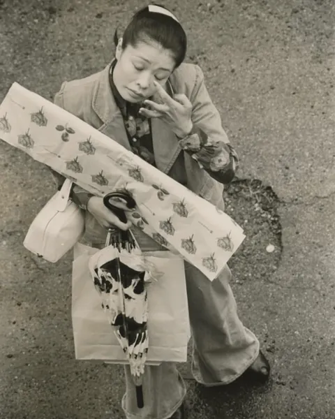 In 1973, Masahisa Fukase photographed his wife, Yōko Wanibe, leaving for work each day from their apartment window in Tokyo.