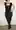 This black dress hugs every curve. 51yo