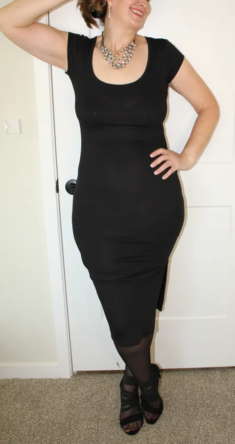 This black dress hugs every curve. 51yo