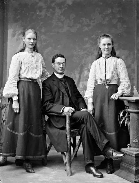 Irish Priest poses with his 2 sisters, one smiles for their photo, 22 of August 19003, glass negative.