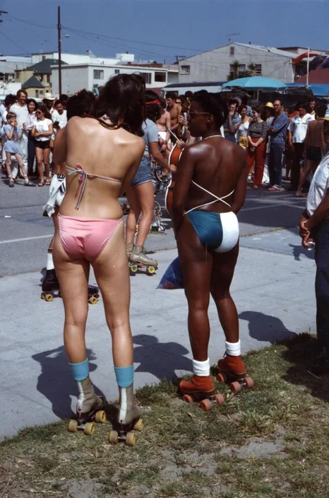 Venice Beach California during the late 1970s roller skate craze. Still has some 70s vibe but you can feel the 80s coming.