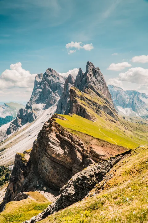 Where green fields meet jagged peaks. Seceda, Italy. [OC][4000x6000]