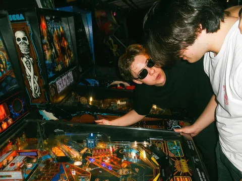 ITAP of my friends playing on a Flipper Machine 
