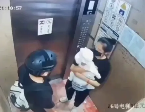 Courier protects mom and baby as an elevator malfunctions 