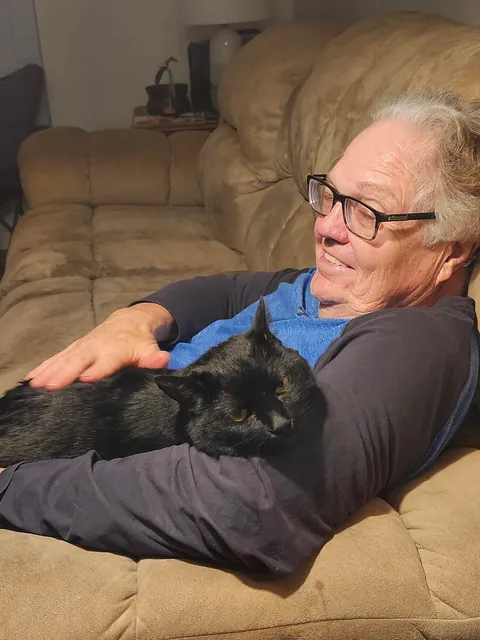 After almost two YEARS, my sweet but very anxious kitty Chompy snuggled up into my dad's arms for the first time ever.