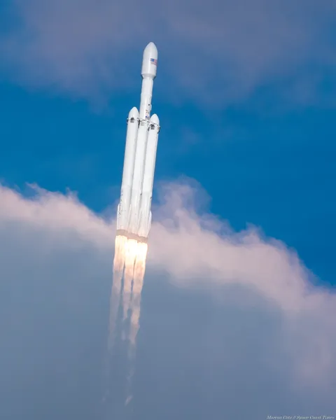 I photographed Falcon Heavy passing through clouds that temporarily revealed more detail of its three 9-engine cores.