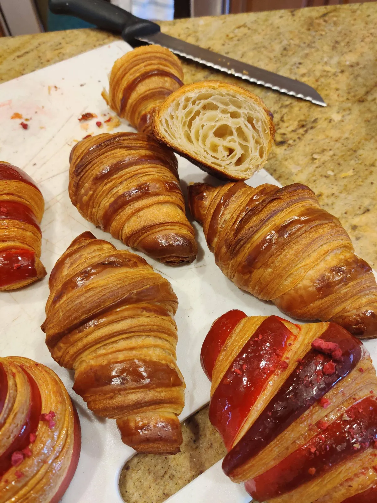 Some croissants I made today. The red ones are filled with rose-lychee cream and raspberry jam!