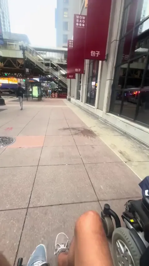 Electric wheelchair user offers a ride to a manual wheelchair user