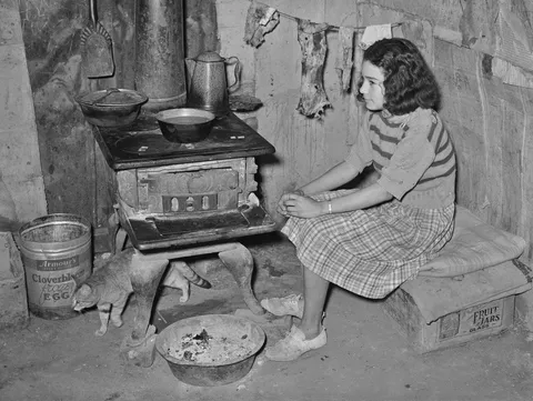 A girl and her cat in her family's kitchen in San Antonio, 1939
