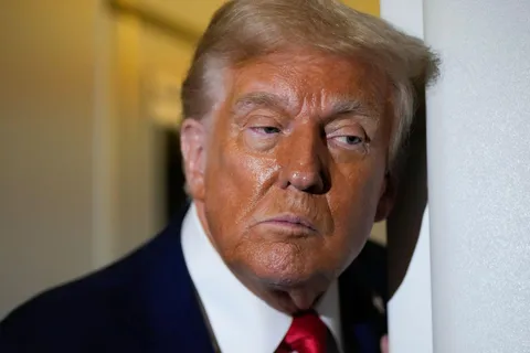 Trump talks to reporters with a disturbingly orange face after attending Kirk memorial on 9/21/25 AP