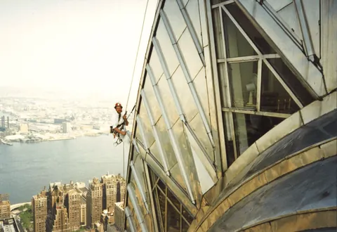 Checking the steel spire of the Chrysler Building for water leaks, New York