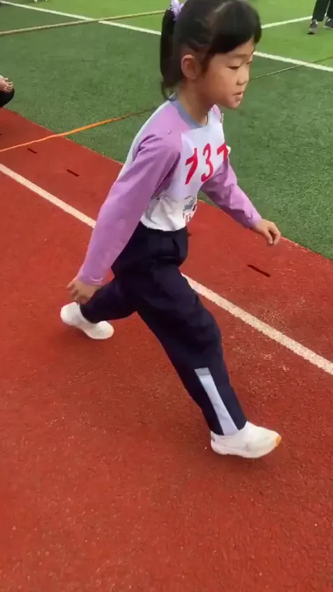 Little girl throws a white ball