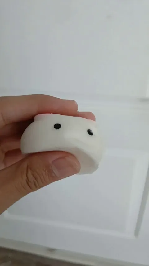 My squishy fidget toy is just sticky enough to roll down my door