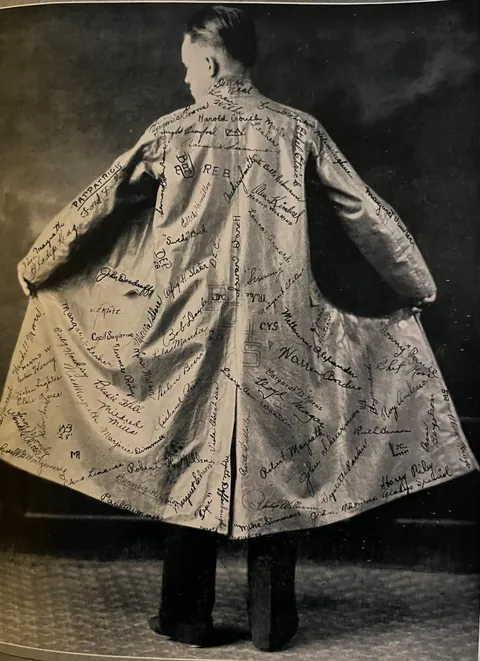 High school graduate with coat signed by classmates 1920s