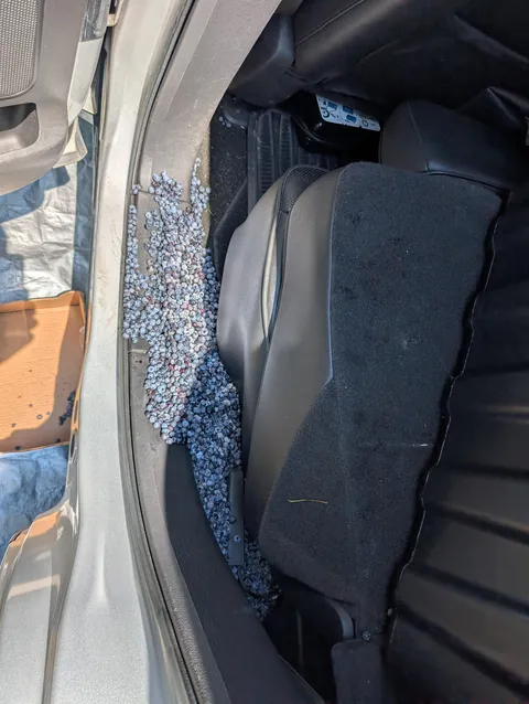 Entire 2 L container of frozen blueberries poured between/under the seat during heatwave