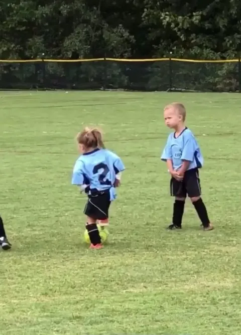 Two little soccer rivals went for the ball and ended up hugging instead