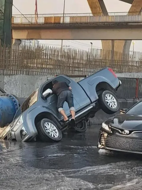 Bangkok, Thailand today. Linked to ruptured 1,000-mm water pipeline, pickup truck fell into the hole, causing severe traffic