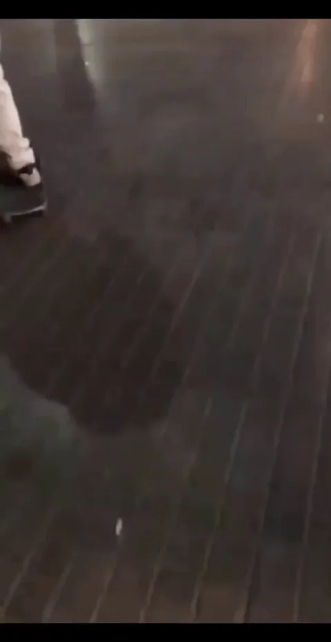 Man snatches someone's skateboard and throws it onto the road.