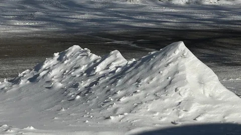 This snow in front of my house looks like a mountain range