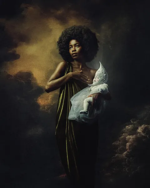 A woman nursing the moon. Shot all in camera and built the prop myself.