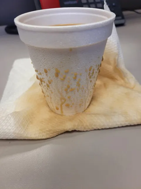 Tea seeping from a styrofoam cup