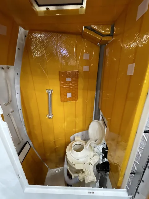 A mockup of Orion’s toilet, also called the Universal Waste Management System, which the Artemis II crew will use.