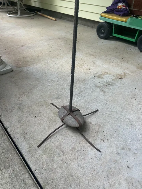 A rock at my grand parents house that has been caged to never touch the ground again.