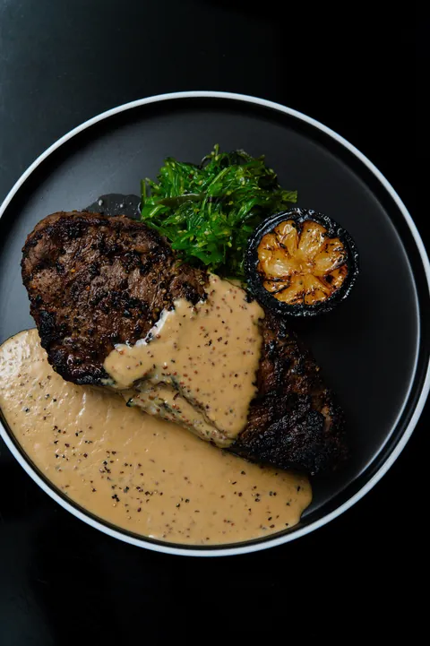 [homemade] grilled steak, seaweed salad and pepper cream sauce.