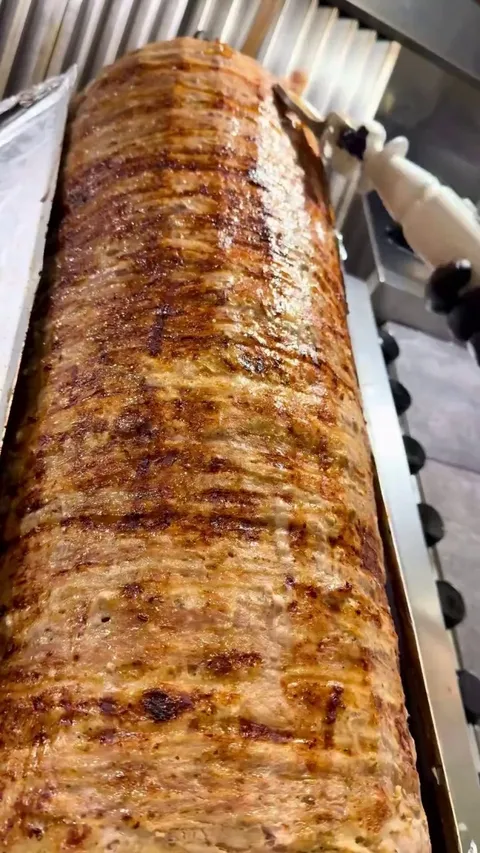 Peeling off meat strip from a meat tower