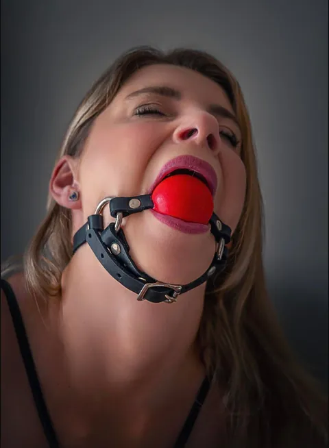 Aww I think she wants the cuffs and gag off