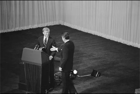 When Reagan walked across to shake Pres Carter's hand