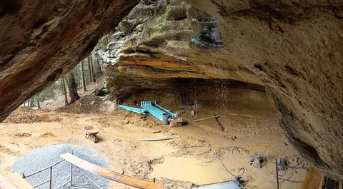 Is building under a huge rock like this safe? My first thought when I say this was earthquakes.